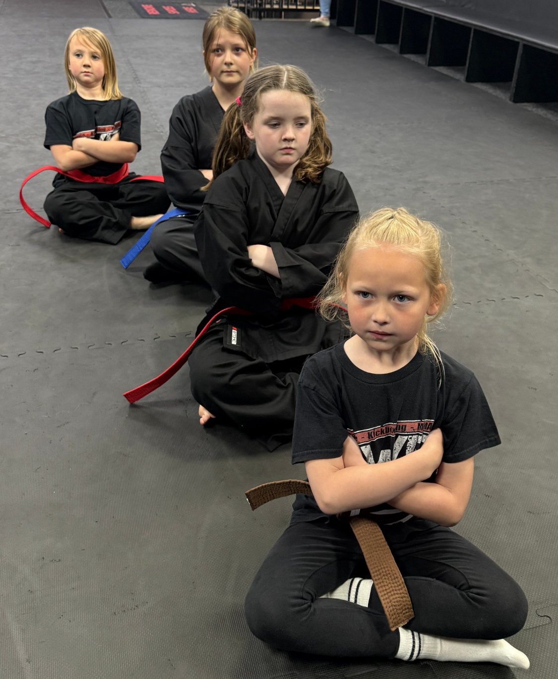Girls sitting in line in a kids karate class at EWF Martial Arts Market Harborough