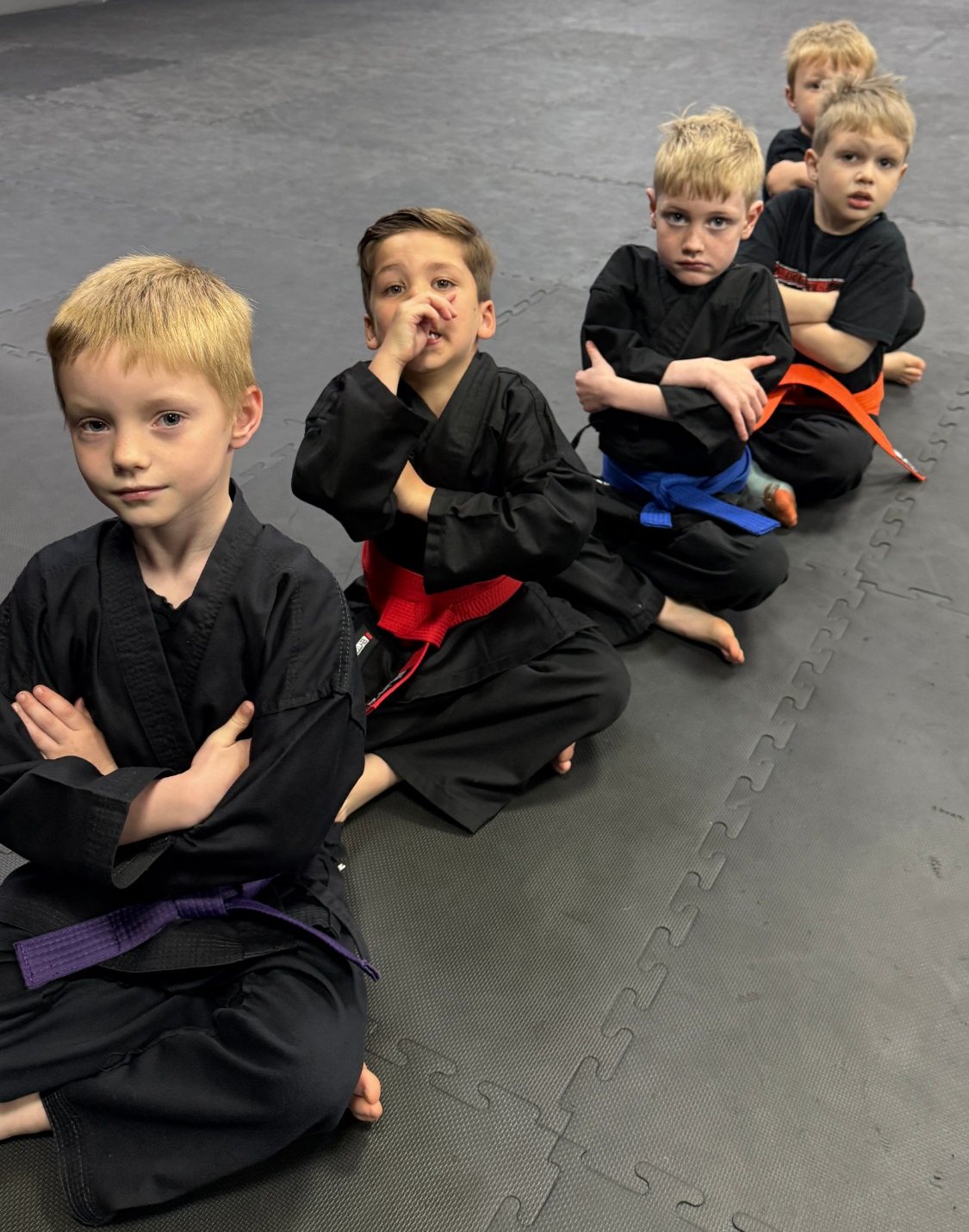 Boys sitting in line in a kids karate class at EWF Martial Arts Market Harborough